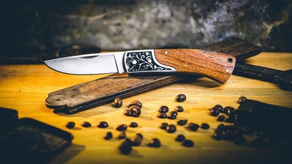 Opened pocket knife over a vintage ruler on the wooden surface - obrazy, fototapety, plakaty