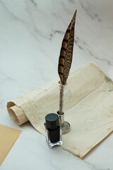 Closeup shot of a vintage parchment with ink and a quill pen