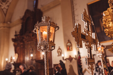 Cross and lighted lantern inside a church