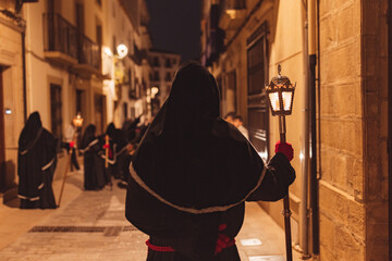 Penitent with his back turned in procession