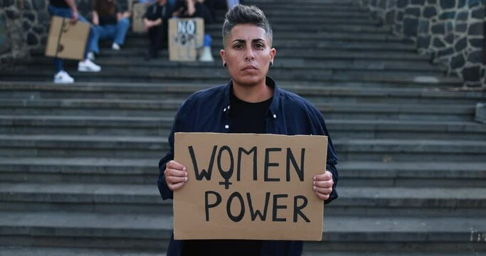Female activists holding woman power banner before demonstration