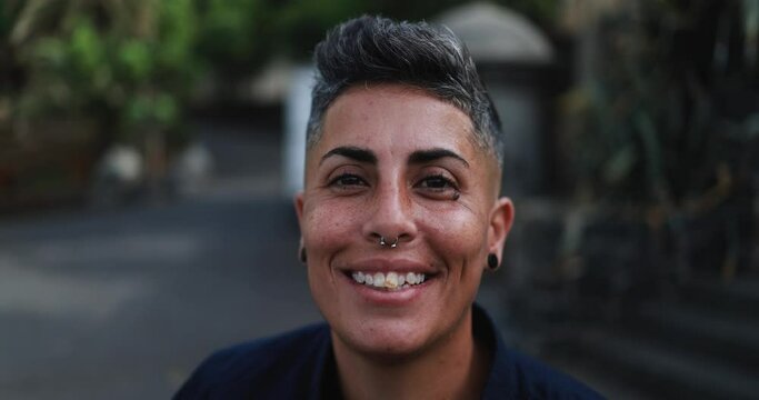 Gay woman smiling in front of camera outdoor 