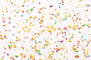 Easter background. Sprinkling with sugar balls and eggs, decoration for cake and baked goods.