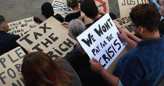 Crowd of multiracial people prepare banners against inflation and financial crisis - Protesters marching for rise cost of living