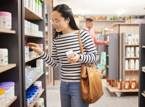 Asian woman, retail shopping and shelf in store for products, grocery stock and choice of brands. Female shopper, customer and supermarket aisle for groceries, sales decision and consumer buying