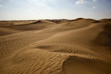 Fototapeta na wymiar Beautiful shot of a dry brown desert under a bright blue sky