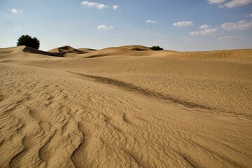 Beautiful shot of a dry brown desert under a bright blue sky