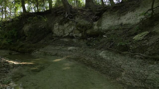 Beautiful view of woods in Lost Creek in Allen TX with river, rocks and light falling from trees