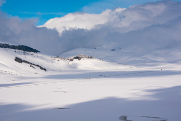 Winter landscape, small town on a hill in a valley covered with snow