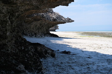 Polished coastline cave next to the sea beach