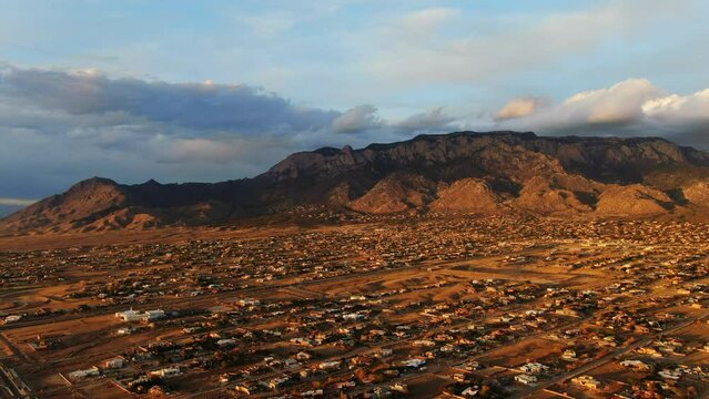 Aerial golden sunset toward Sandia Mountains Albuquerque New Mexico