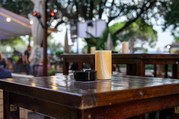 Ashtray and candle on the table