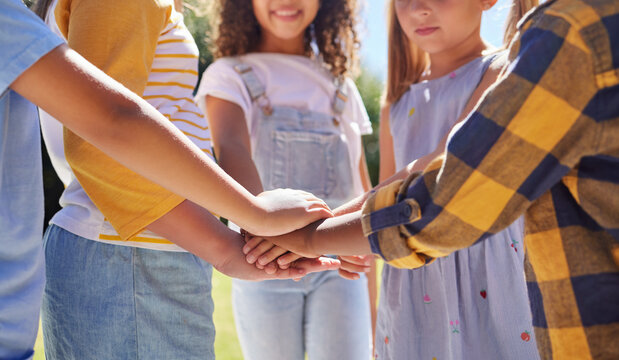 Hands together, support and children outdoor, solidarity and trust with motivation, games or growth. Closeup, kids or youth group with gesture for teamwork, commitment or fun with development or goal