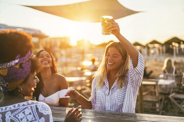 Happy girls having fun drinking cocktails at bar on the beach - Soft focus on african girl face