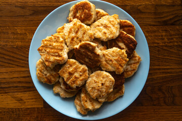 Chicken cutlets on a plate. Chicken nuggets. View of the dish from above