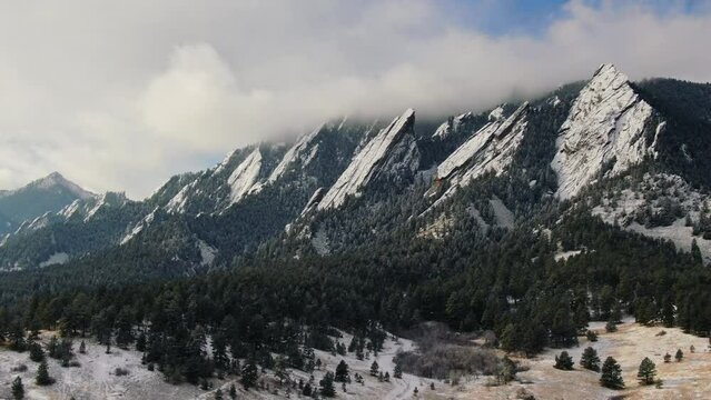 Trail hike Chautauqua hiking trail Boulder Flat Irons freezing cold winter orange drone aerial upward motion Colorado
