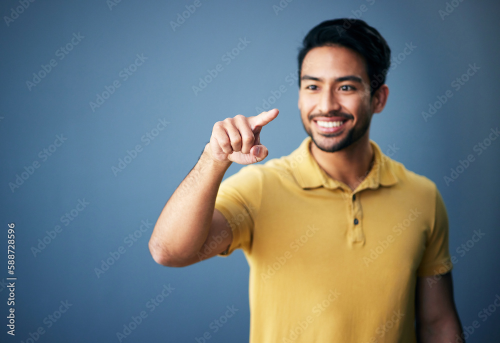 Poster happy, finger and man in studio with hand for mockup space or ai on a blue background. smile of an a