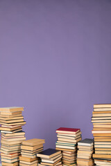 stacks of books scientific literature of knowledge in the library on a purple background