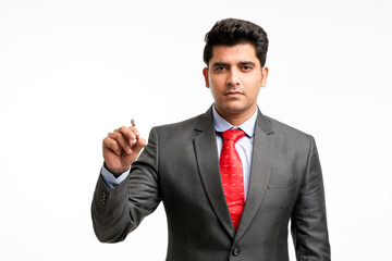 Young businessman pointing in front of with pen