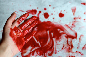 Bloody messy scene on light grey background with copy space. Bloody knife close up photo. Murder Domestic violence concept. 