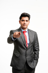 Young indian businessman pointing in front off with finger.