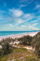 Fototapeta na wymiar Mesmerizing view of the Peregian beach with rolling waves of Pacific ocean, Sunshine Coast, Queensland, Australia. Beautiful cloudscape.