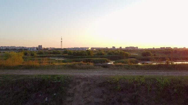 Stunning Vacaresti Delta from Above, Rich Foliage Amidst Azure Skies, with Majestic High-rises in the Distance, Romania