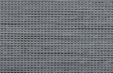 A close-up of a dark fabric with an intricate, ordered weave.