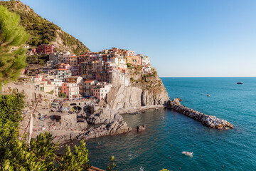 Manarola, a coastal town in Italy, showcasing the colorful houses that line the steep hillsides...