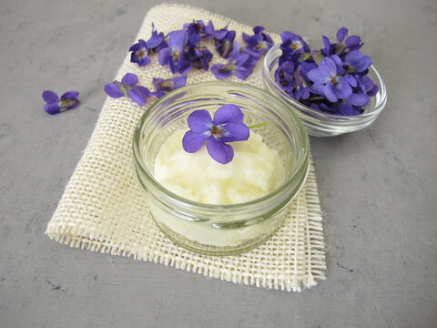 Homemade solid deodorant with sweet violet scent in a glass jar