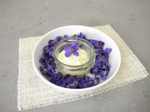 Homemade solid deodorant with sweet violet scent in a glass jar