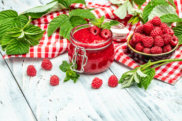 Raspberry jam with berry on light background. Homemade jam with raspberry. banner, menu, recipe place for text, top view