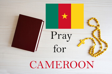 Pray for Cameroon. Rosary and Holy Bible background.