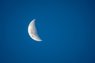 Obraz na płótnie Canvas Half Moon in the Blue Night Sky