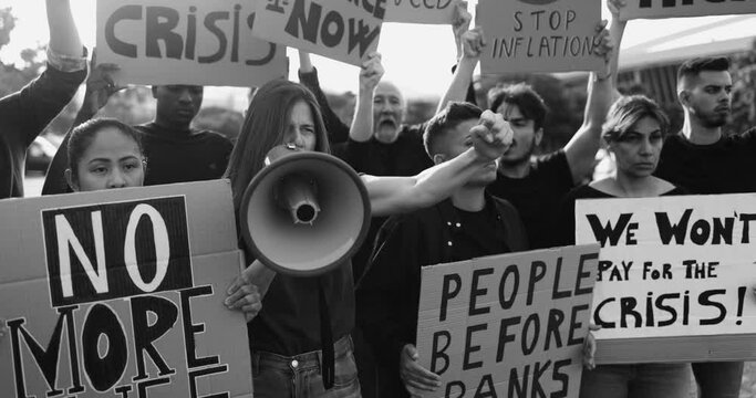 Group of multiracial people protest against inflation and financial crisis - Protesters marching for rise cost of living outdoor - Black and white editing