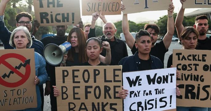 Group of diverse people protest against inflation and financial crisis - Multiracial protesters marching for rise cost of living in the city