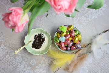 Pink tulips for easter, malted rye and Easter chocolate Eggs on table in Finland