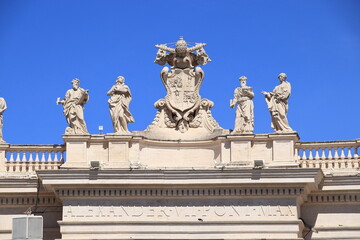 Fototapeta na wymiar St. Peter's Basilica Colonnade Top Sculptures Close Up in Rome, Italy