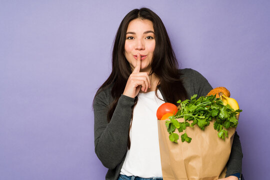 Beautiful Woman Keeping A Secret Grocery Shopping