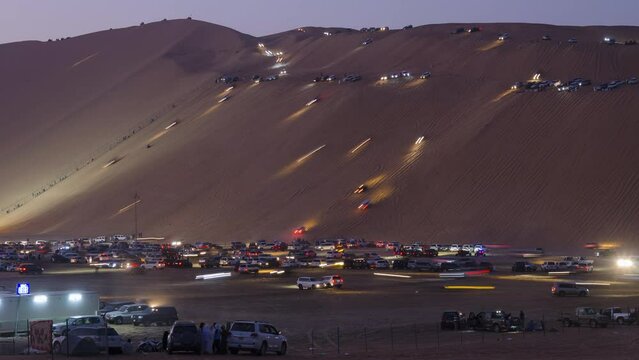 Liwa Moreeb dune car race festival in Abu Dhabi, visitor enjoy riding in the tallest sand dune