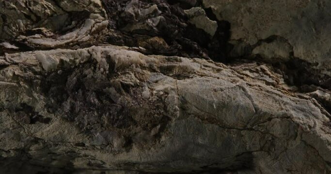 grey stone texture close-up. rought mountain surface. macro shot of a rock. natural mineral background. 