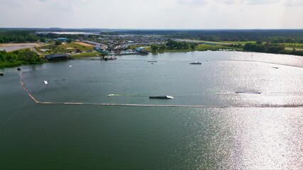 People Water Skiing At an Obstacle Course At Lake Myrtle Sports Park In Auburndale, Florida - Aerial Slow Orbit