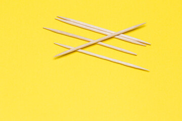 Toothpicks on a yellow isolated background