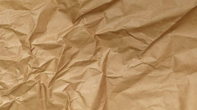 Brown crumpled craft paper texture background, stop-motion, eco friendly,recycle paper, space for text moving