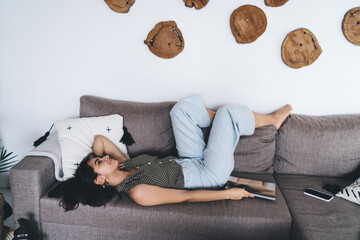 Woman napping on sofa in living room