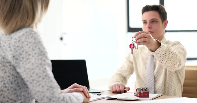 Agent hands over keys to property for meetings in office. Signing a lease or sale agreement