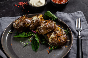 Baked potatoes in their skins with spices in a bowl