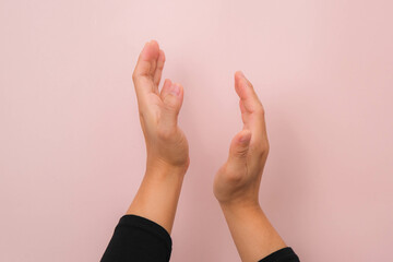 Woman clapping hands isolated on pink background. Close up of female hands applauding.
