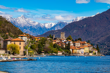 The village of Santa Maria Rezzonico, on Lake Como, photographed on a spring day, with its tower and the Alps in the background.