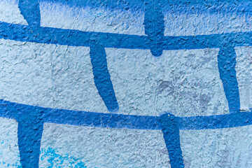 Fototapeta na wymiar urban street art in painting on the wall aerosol graffiti in shape of net or bricks, netting strusture drawing on city wall
